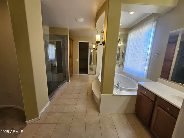 a white toilet sitting next to a white sink and vanity