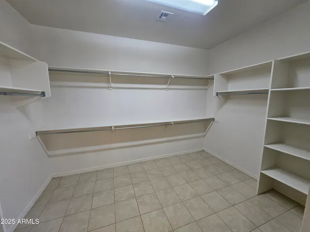 en empty room with windows and fan