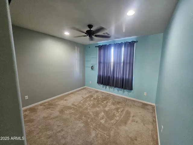 an empty room with windows and closet