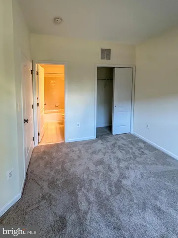 a bathroom with a granite countertop sink a toilet a mirror and bathtub