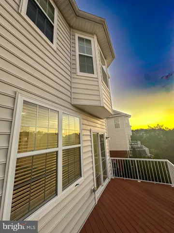 a view of a balcony with wooden floor and fence