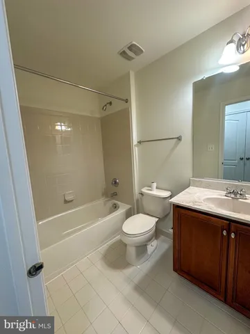 a white toilet sitting next to a bath tub