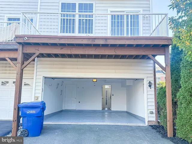 an empty room with wooden floor cabinet and windows