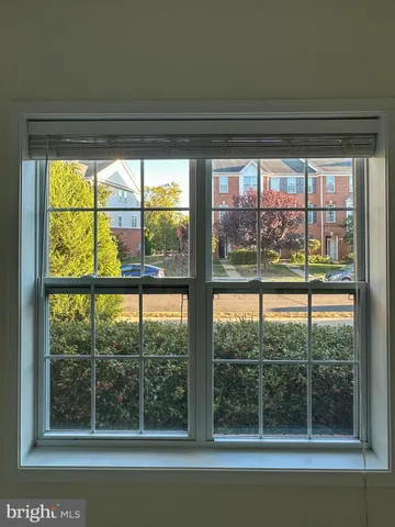 an empty room with closet and windows