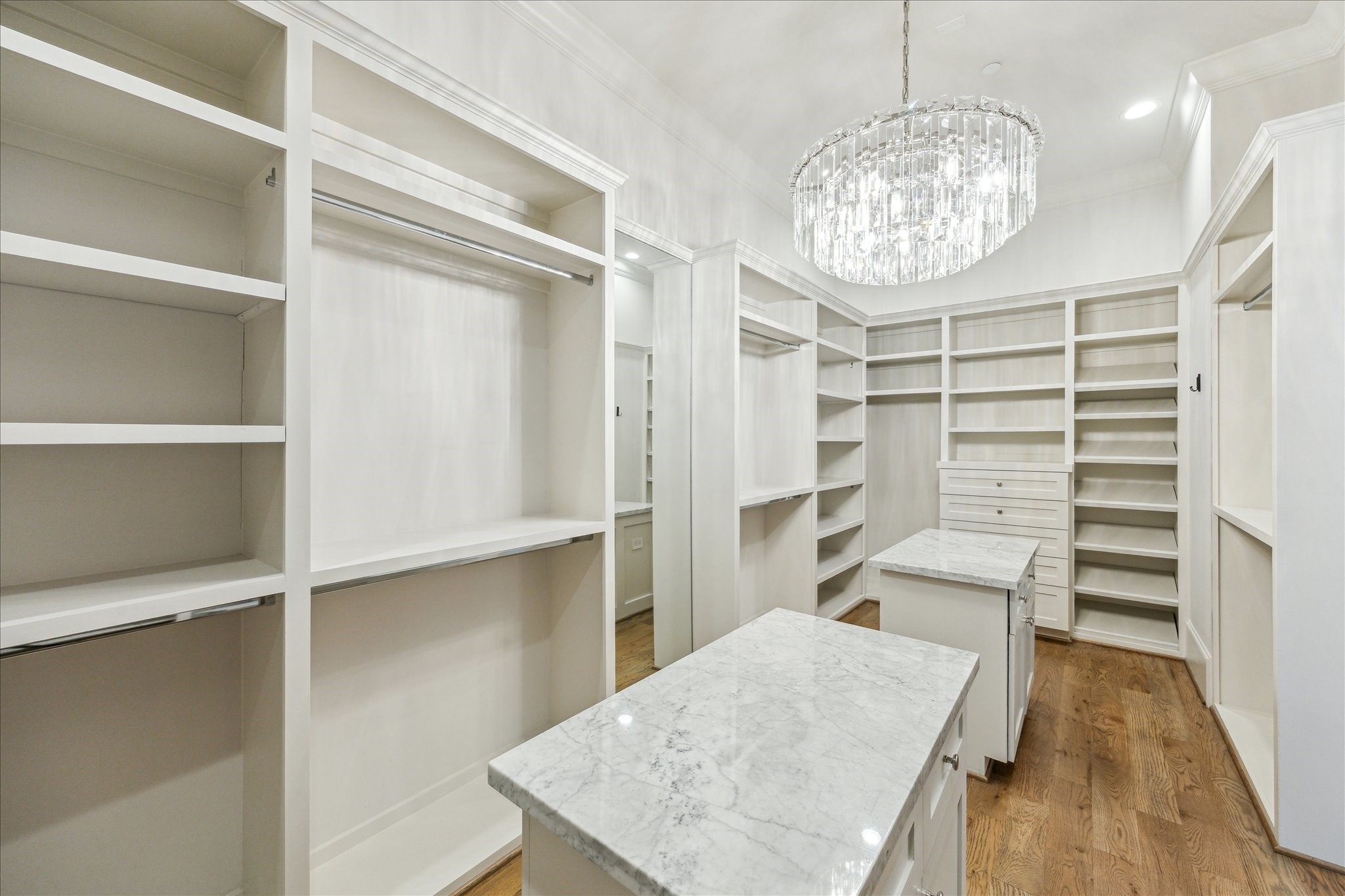 2103 Argonne Street, Unit B Houston, TX 77019 - Photo 17 of 28 Large primary closet features two packing islands with storage, long & short hanging, shoe and shelf storage.