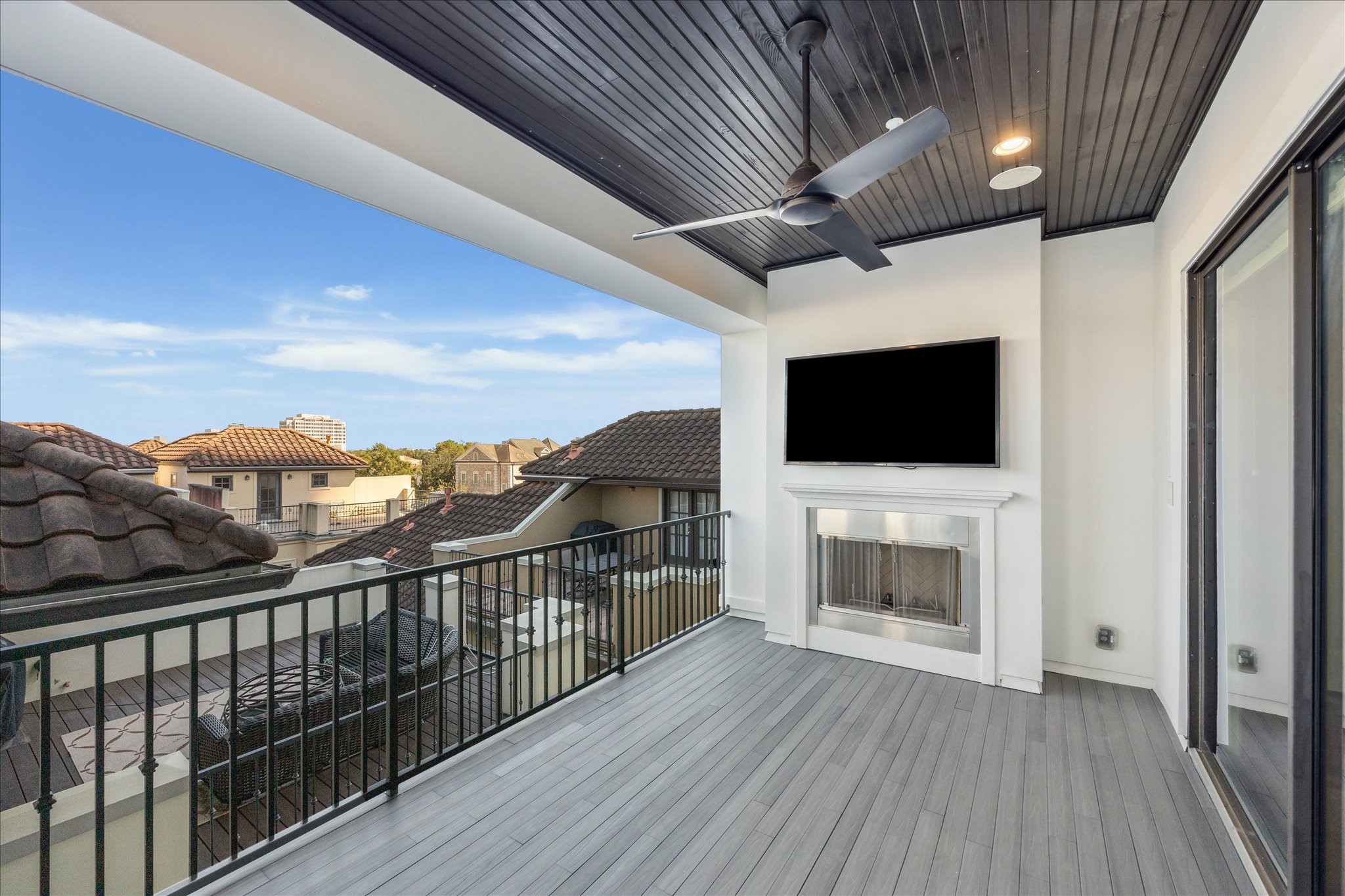 2103 Argonne Street, Unit B Houston, TX 77019 - Photo 24 of 28 4th floor covered deck with fireplace, outdoor TV, and summer kitchen.
