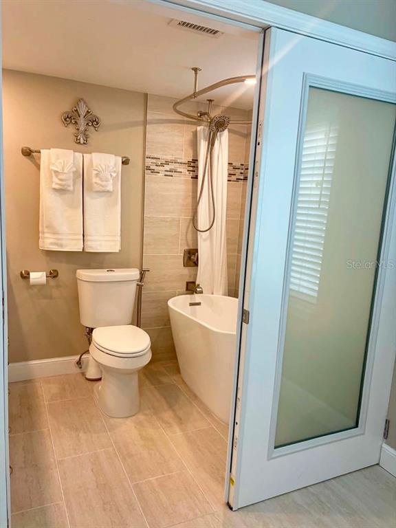4455 Duhme Road, Unit 103 St. Petersburg, FL 33708 - Photo 20 of 37 a bathroom with a toilet and a shower