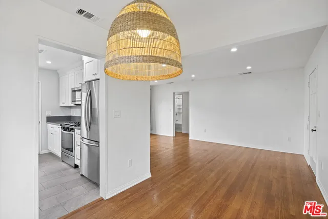 a view of kitchen and empty room