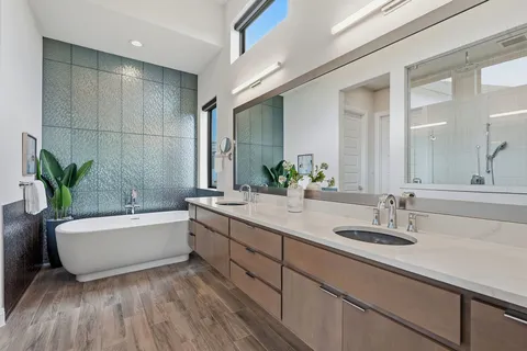 a bathroom with a double vanity sink and a bathtub