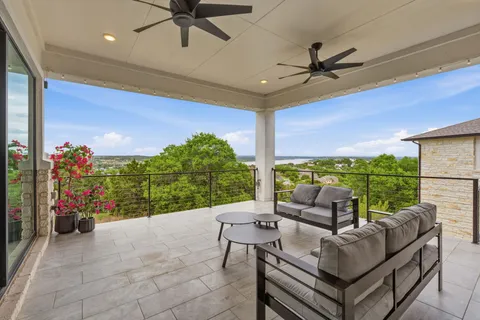 a living room with patio furniture and a potted plant