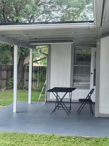 a view of two chairs in the patio
