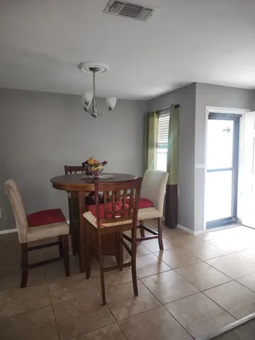 a dining room with furniture and window