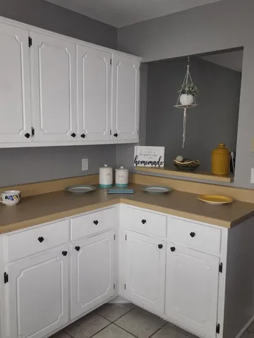 a kitchen with white cabinets and a sink