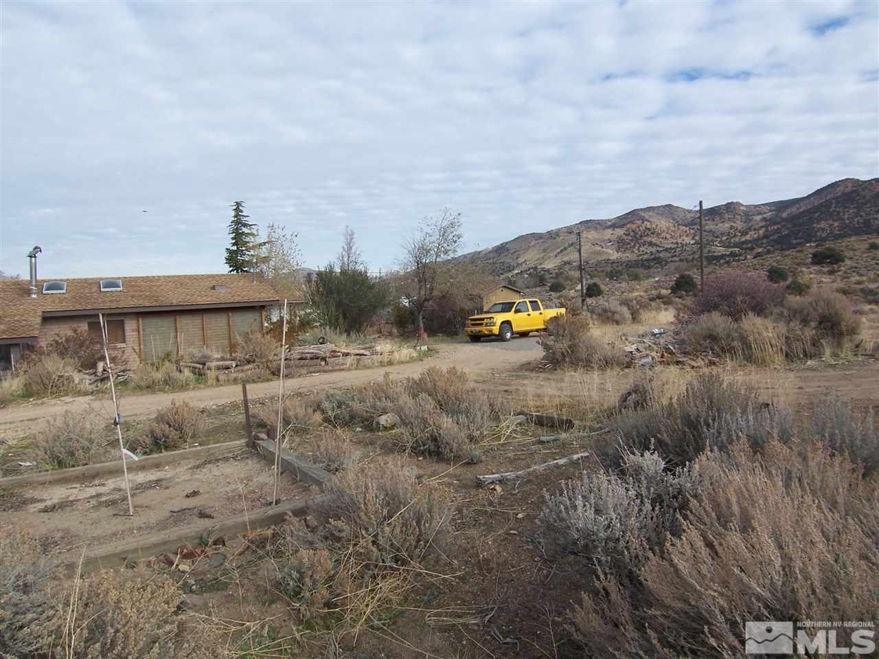 15915 Secret Pass Road Reno, NV 89521 - Photo 8 of 9 a view of a house with a mountain and a yard