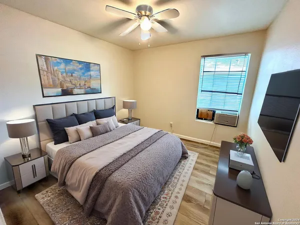 a bedroom with bed and a chandelier