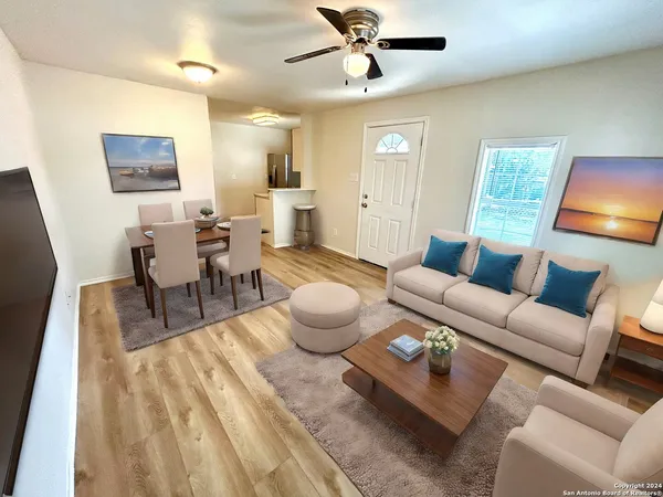 a living room with furniture and a wooden floor