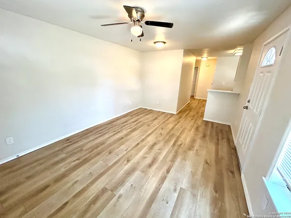 a view of empty room with wooden floor