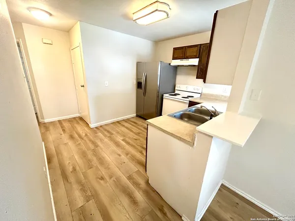 a view of a kitchen from a room