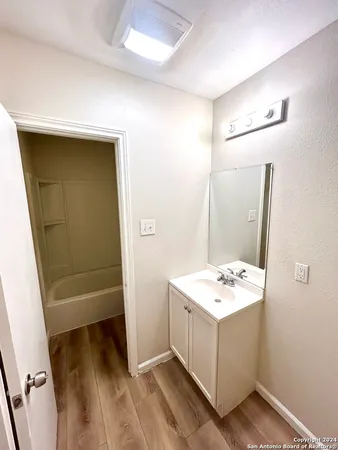 a bathroom with a sink a toilet and a mirror
