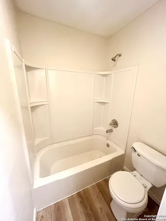 a bathroom with a toilet and bathtub