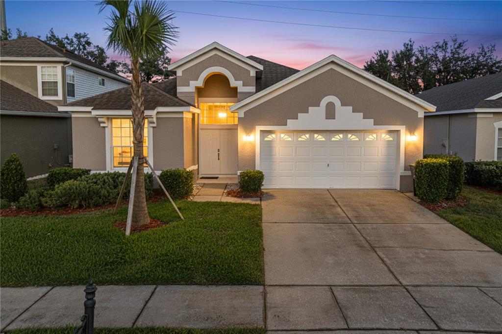 8204 Fan Palm Way Kissimmee, FL 34747 - Photo 1 of 1 a front view of a house with garden