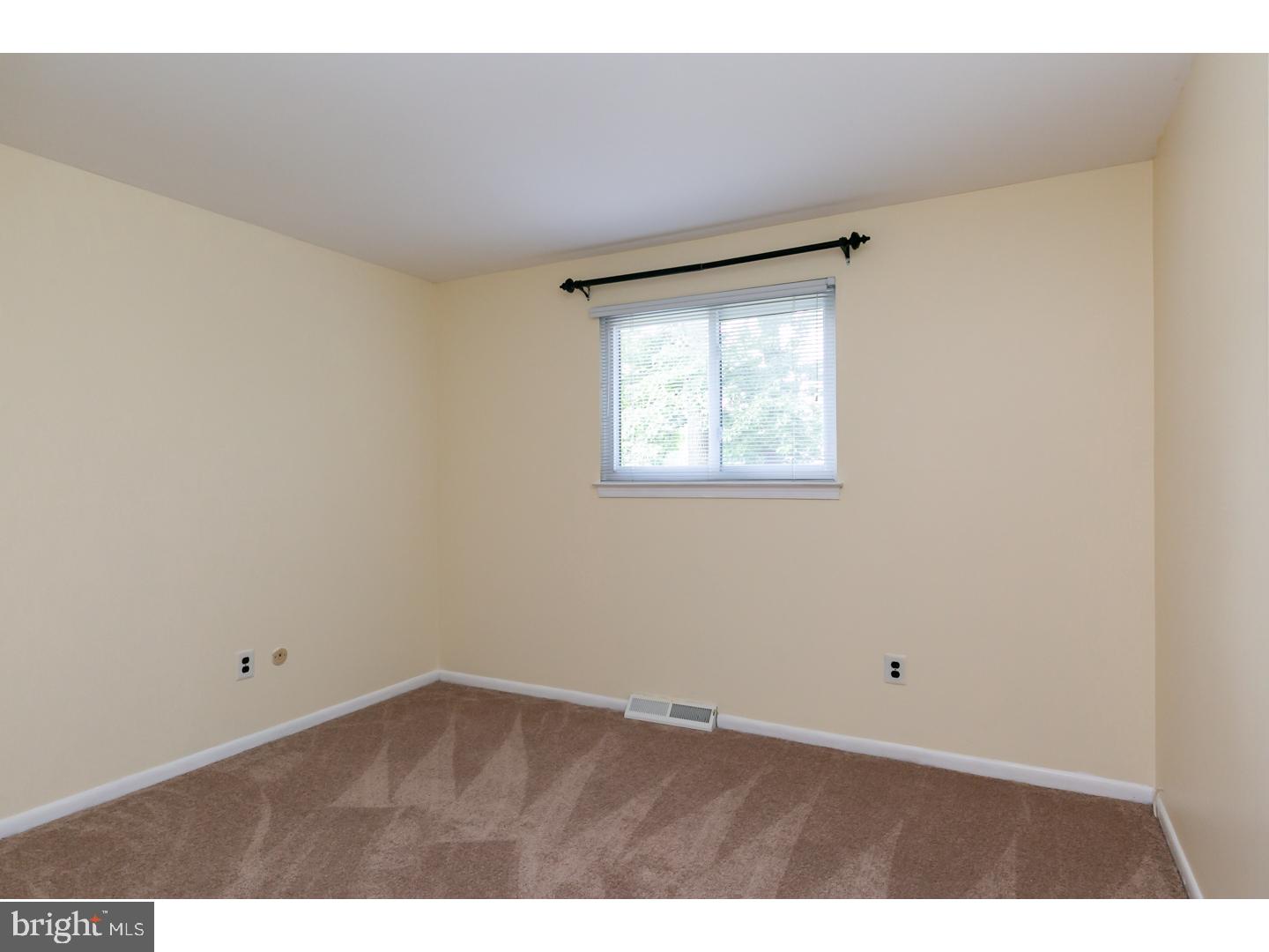 151 Antietam Road Delran, NJ 08075 - Photo 20 of 24 a view of an empty room with wooden floor and a window