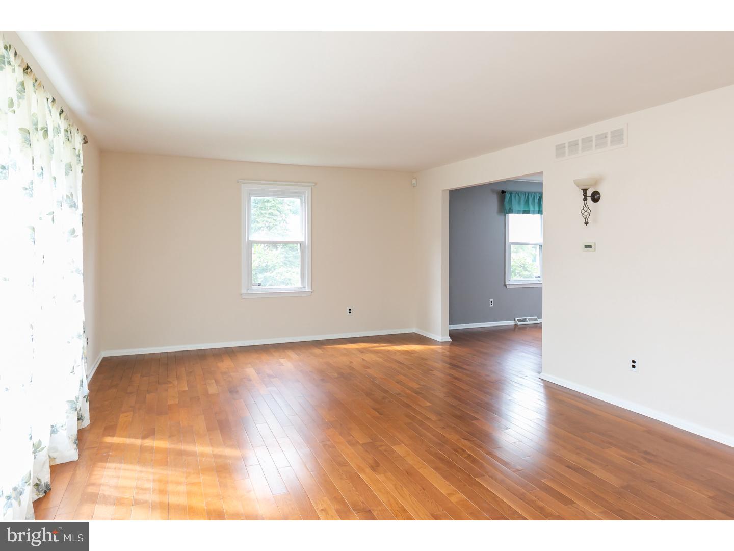 151 Antietam Road Delran, NJ 08075 - Photo 3 of 24 a view of an empty room with wooden floor and a window