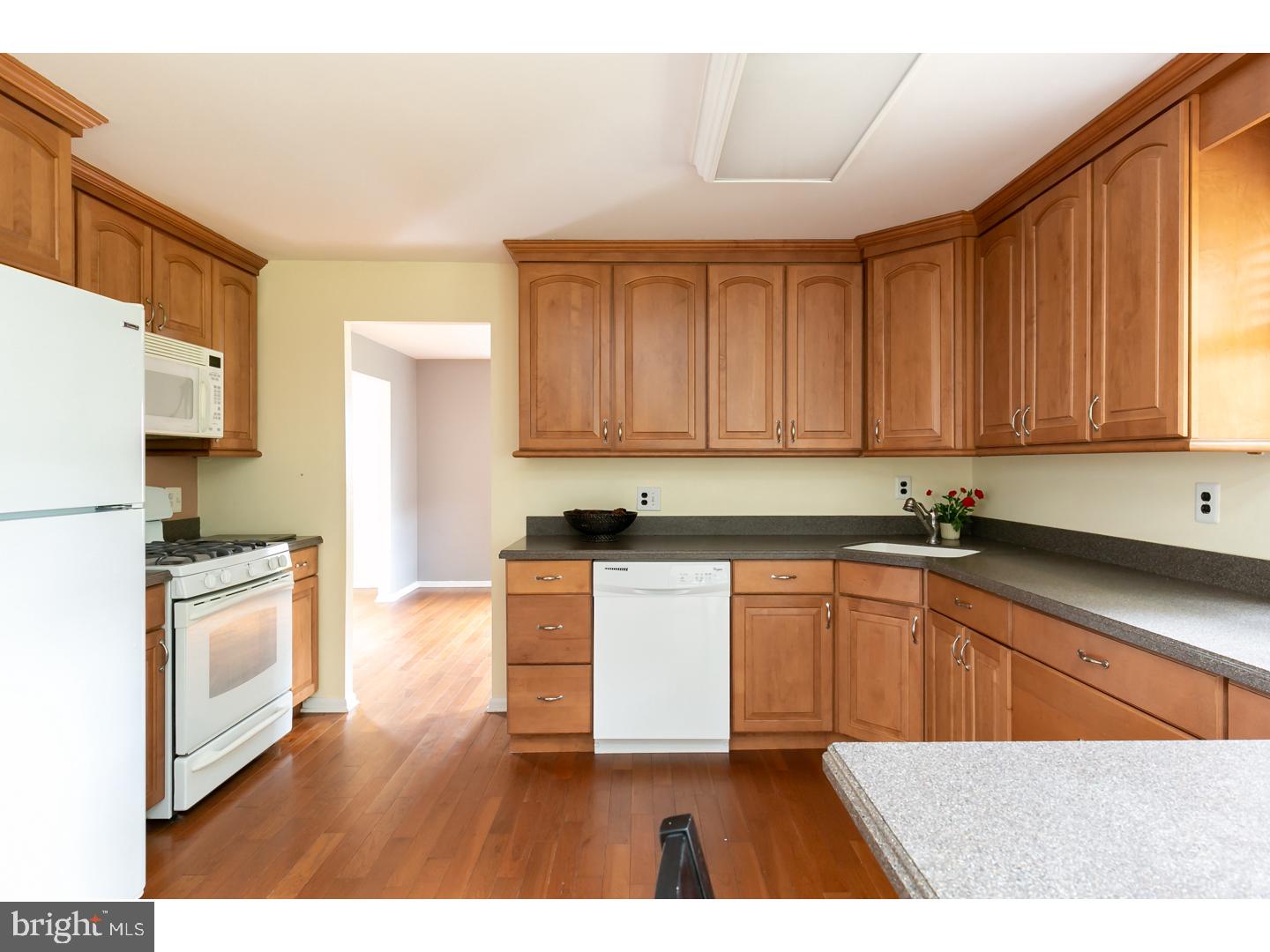 151 Antietam Road Delran, NJ 08075 - Photo 7 of 24 a kitchen with stainless steel appliances granite countertop a stove a sink dishwasher and a refrigerator with wooden floor
