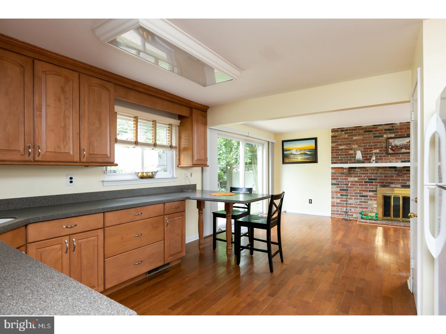 151 Antietam Road Delran, NJ 08075 - Photo 10 of 24 a kitchen with stainless steel appliances granite countertop a stove top oven a sink dishwasher a dining table and chairs with wooden floor