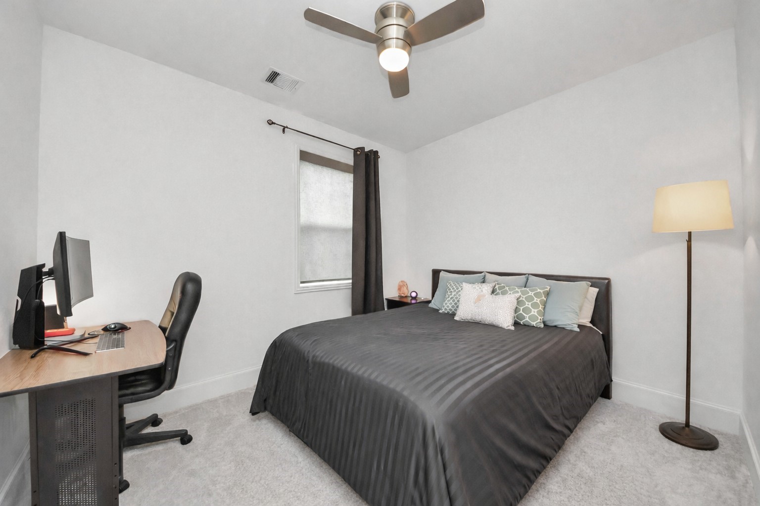 1628 West 24th Street Houston, TX 77008 - Photo 9 of 41 Just up the first few steps, discover a cozy secondary bedroom ensuite, perfect for comfort and functionality. New carpet installed in December 2025!