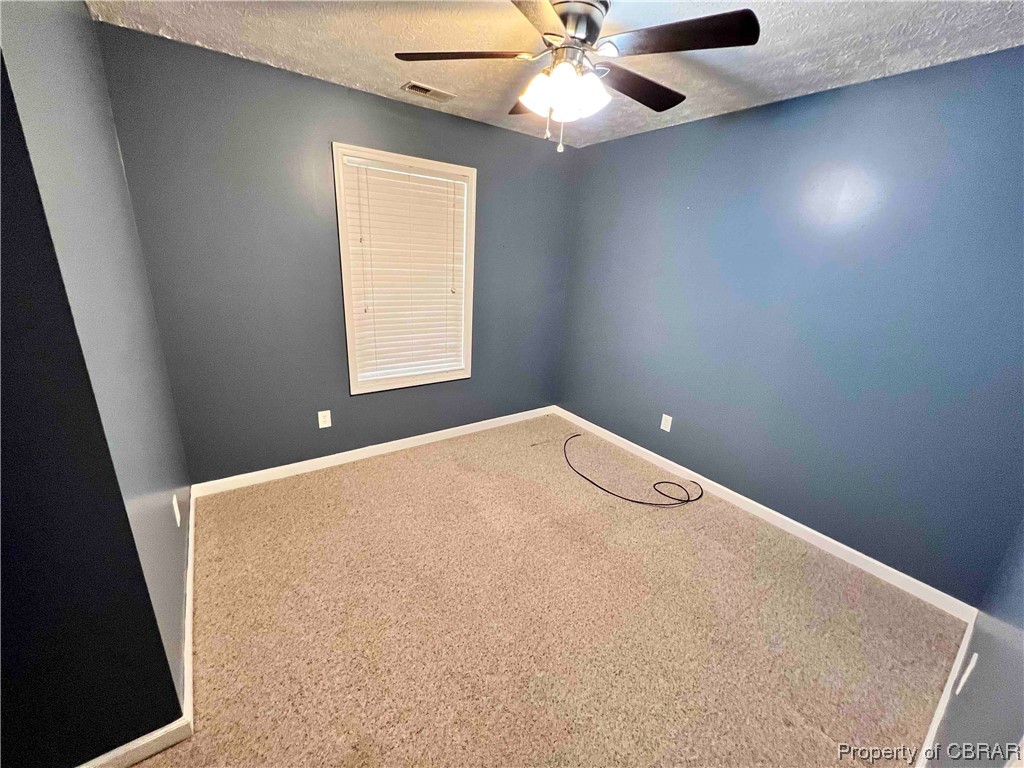 110 Sutherland Street Lancaster, VA 22503 - Photo 12 of 19 an empty room with a window and a fan