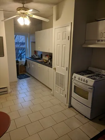 a kitchen with stainless steel appliances a stove a sink and a refrigerator