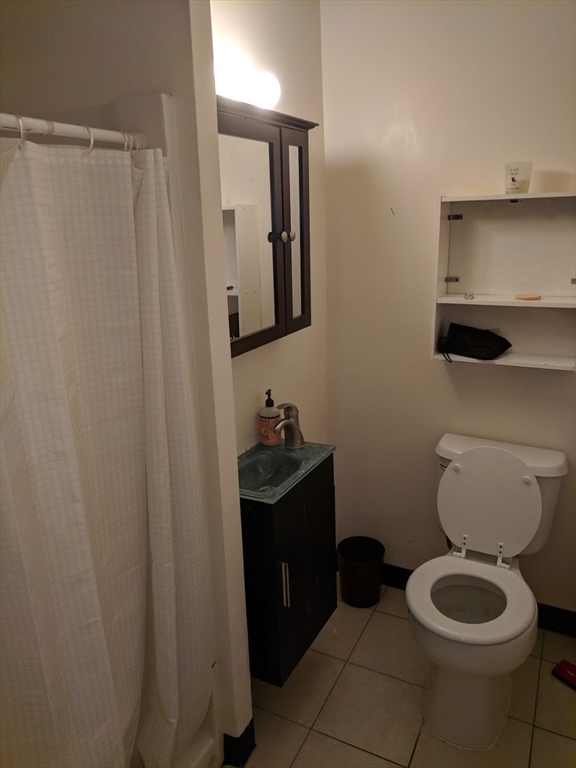 37 Cooper Street, Unit 3 Boston, MA 02113 - Photo 5 of 7 a bathroom with a toilet a sink and mirror