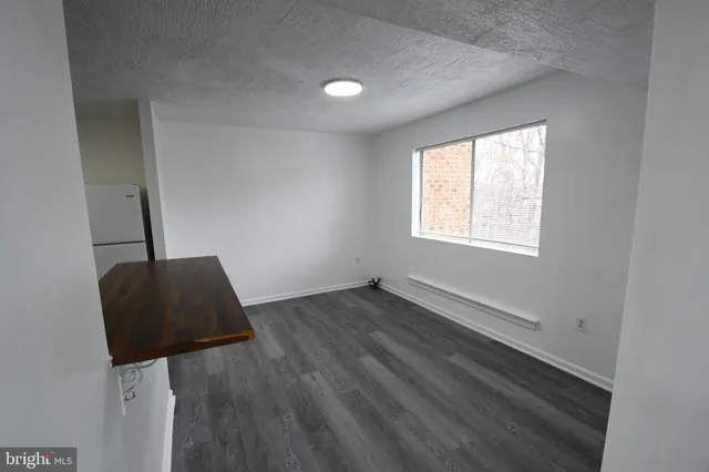 a view of an empty room and wooden floor