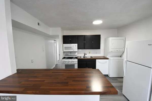 a kitchen with a refrigerator and a stove top oven