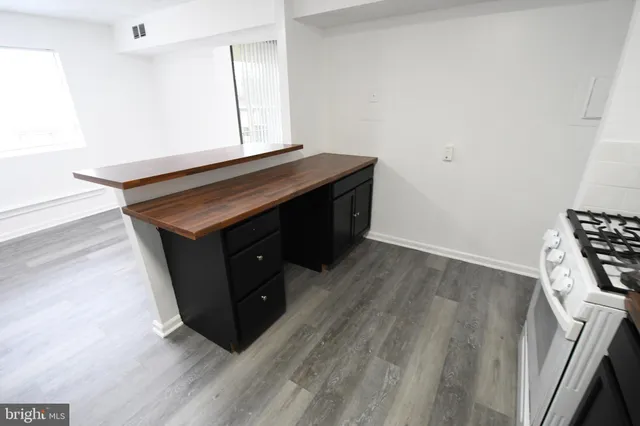 a room with wooden floor and white walls