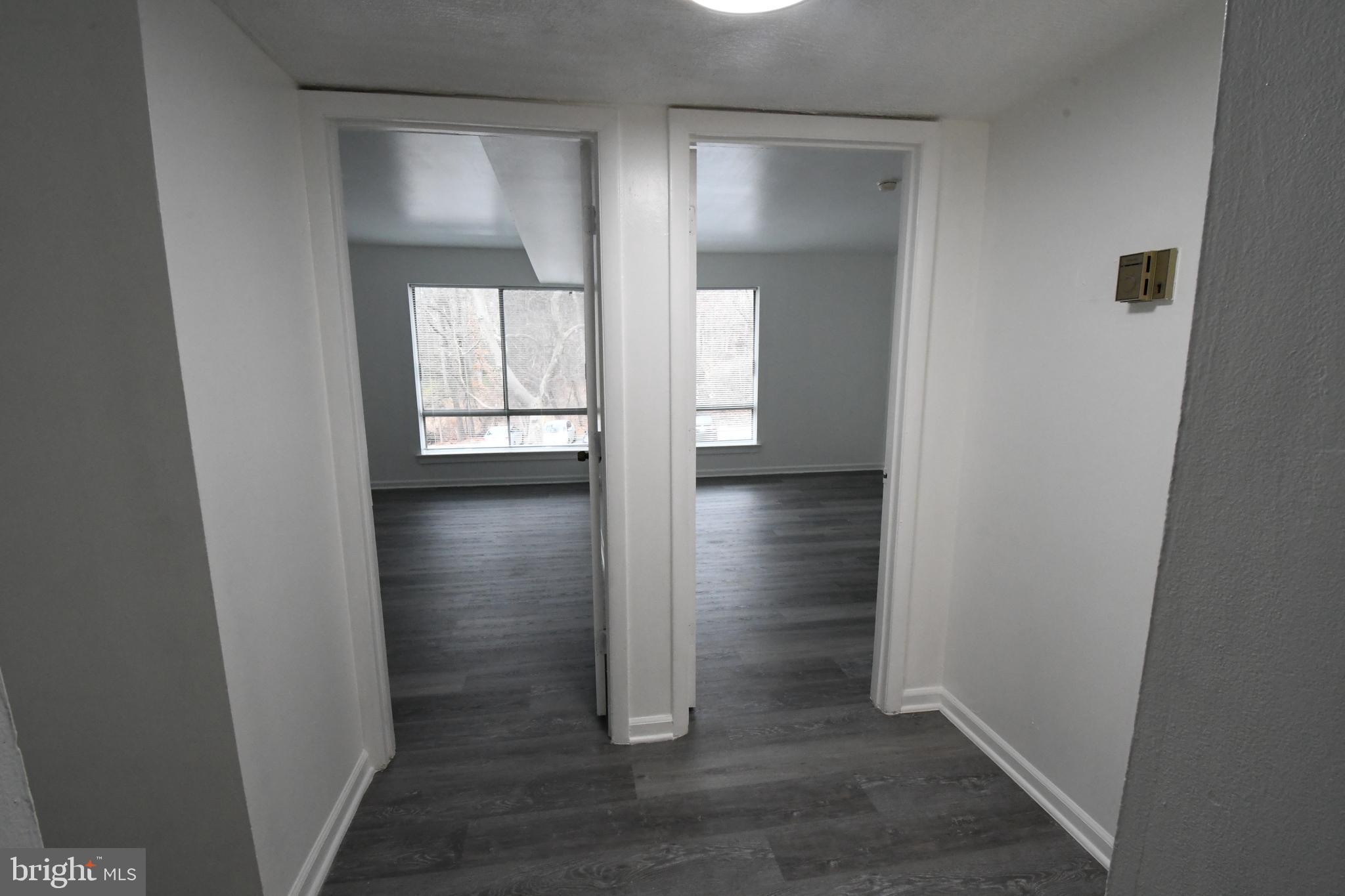 8459 Greenbelt Road, Unit 201 Greenbelt, MD 20770 - Photo 5 of 15 an empty room with wooden floor and windows