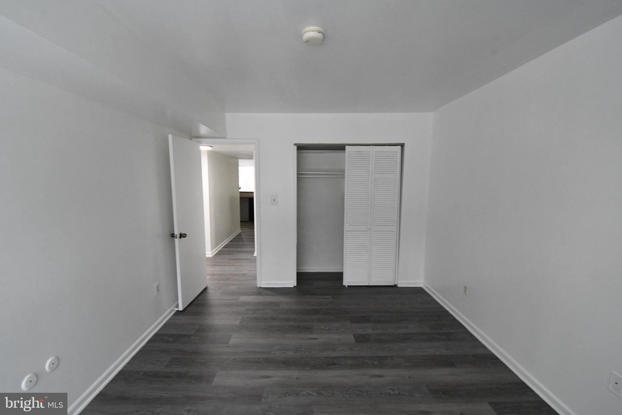 8459 Greenbelt Road, Unit 201 Greenbelt, MD 20770 - Photo 7 of 15 a view of an empty room with wooden floor