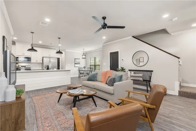 a living room with furniture and kitchen view