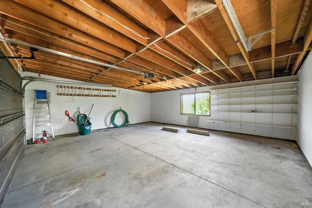 a view of a house with a patio and a yard