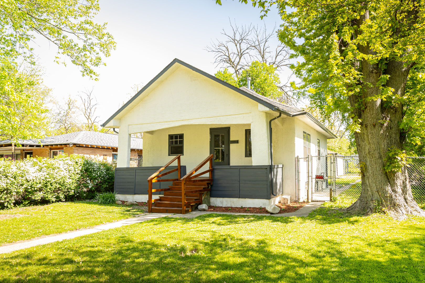 a view of a house with a swimming pool and a yard with furniture