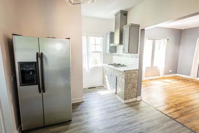 a kitchen with stainless steel appliances granite countertop a refrigerator and a stove