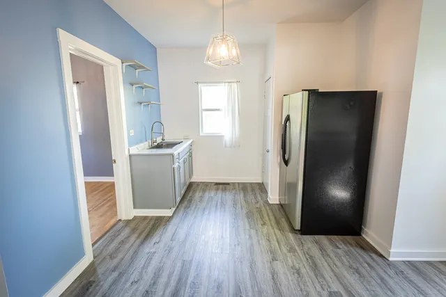 a view of a kitchen from a hallway