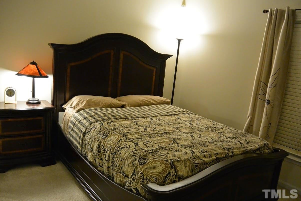 1029 Summerhouse Road Cary, NC 27519 - Photo 11 of 17 a bed sitting in a bedroom next to a window