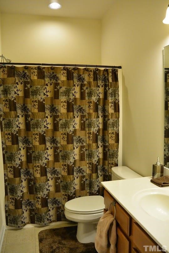 1029 Summerhouse Road Cary, NC 27519 - Photo 13 of 17 a bathroom with a sink a toilet and a shower