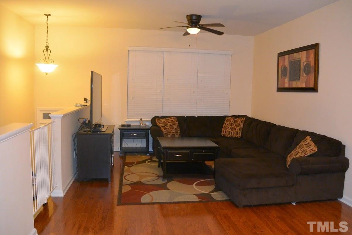1029 Summerhouse Road Cary, NC 27519 - Photo 3 of 17 a living room with furniture and a flat screen tv