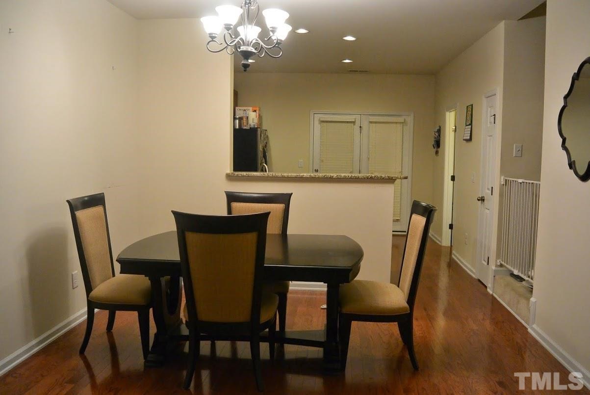 1029 Summerhouse Road Cary, NC 27519 - Photo 4 of 17 a view of a dining room with furniture and wooden floor