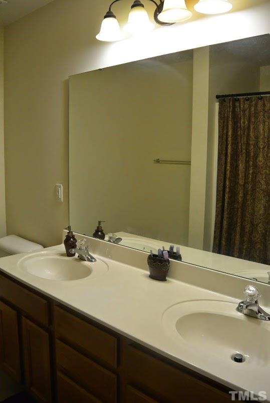 1029 Summerhouse Road Cary, NC 27519 - Photo 10 of 17 a bathroom with a sink and a mirror
