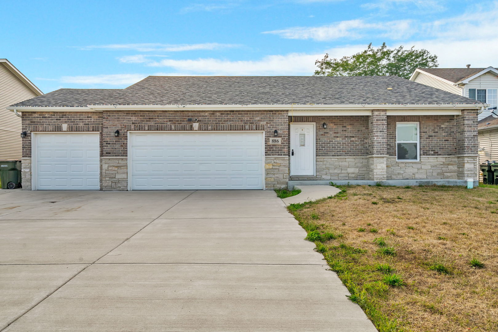 a front view of a house with a yard and garage