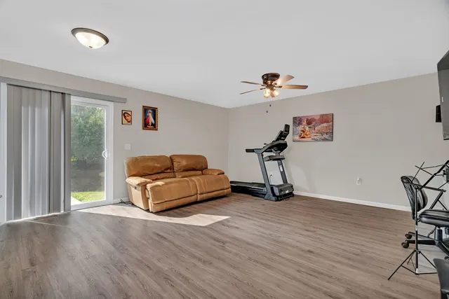 a room with gym equipment and a wooden floor